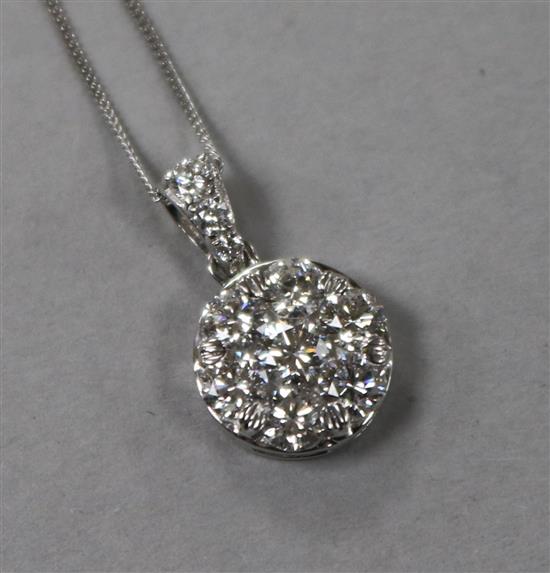 A modern 18ct white gold and seven stone diamond cluster pendant, on an 18ct white gold chain, 17mm.